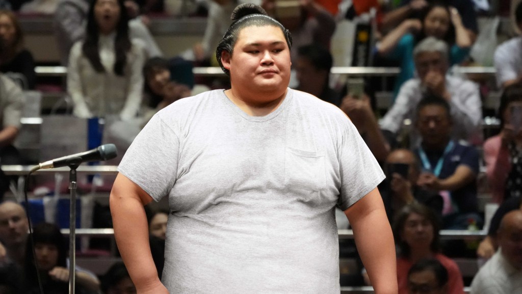 Self-Conscious Sumo Wrestler Wears White T-Shirt Into Ring